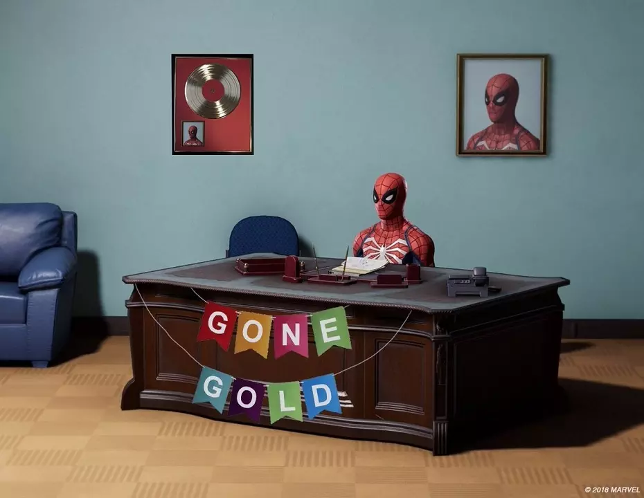 A toy Spider-Man at a desk with the words 