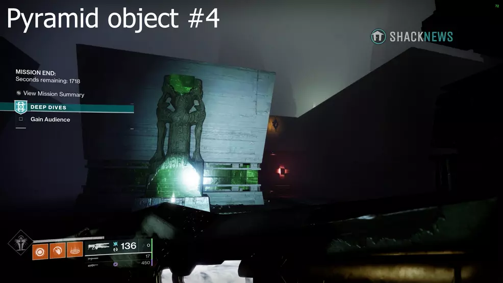 A pyramid object floats in a dark corner behind a green statue