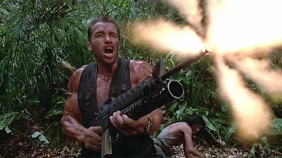 Arnold Schwarzenegger firing a gun in Predator.