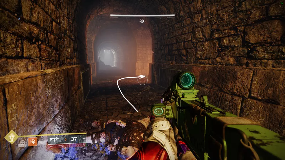 An arrow points around a corner, a spike trap is on the left wall