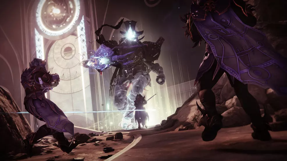 Three guardians fight a large Taken boss in The Coil
