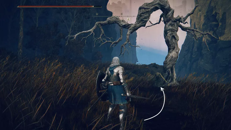 The player stands in front of a kneeling corpse at a tree