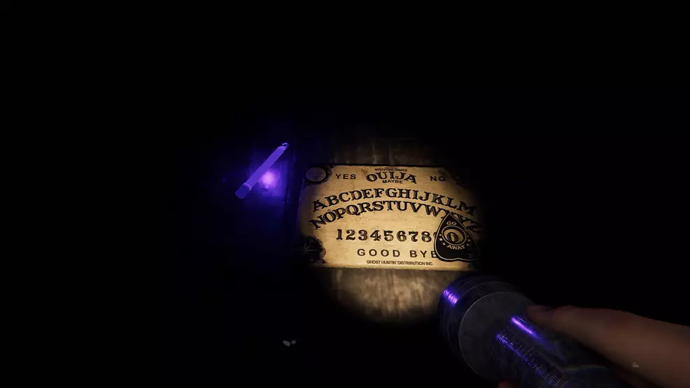 A Ouija board and UV flashlight in Phasmophobia