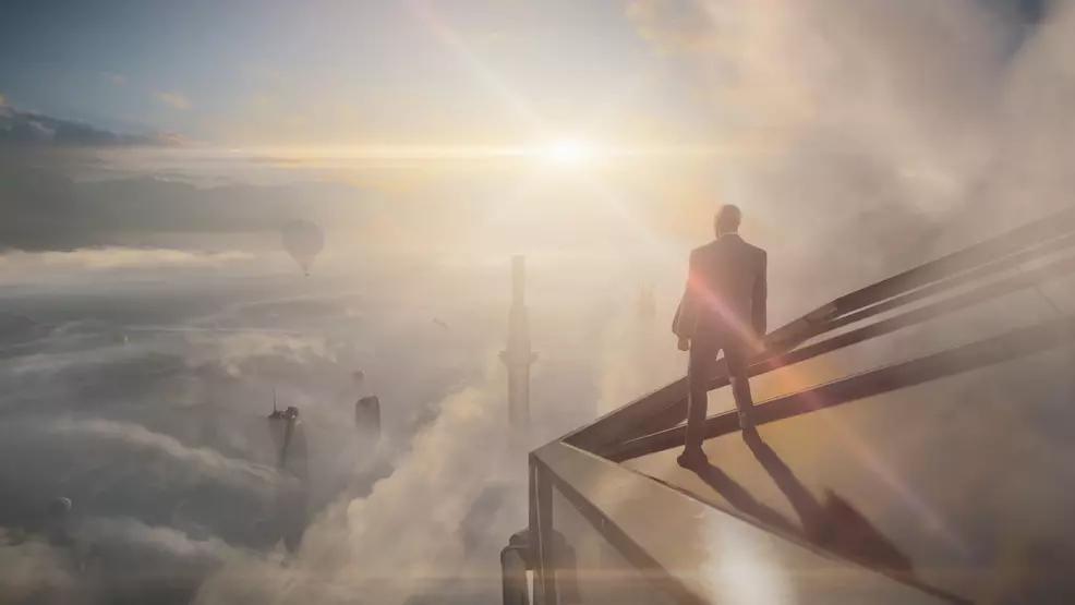 Agent 47 stands on a skyscraper.