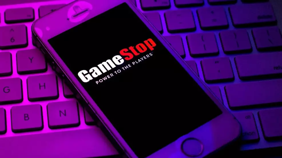 The GameStop logo on the phone screen rests on the keyboard.