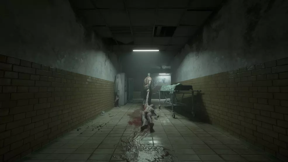A man in BDSM gear dragging a bloody and naked body down a hall leaving a smear of blood behind on the floor.