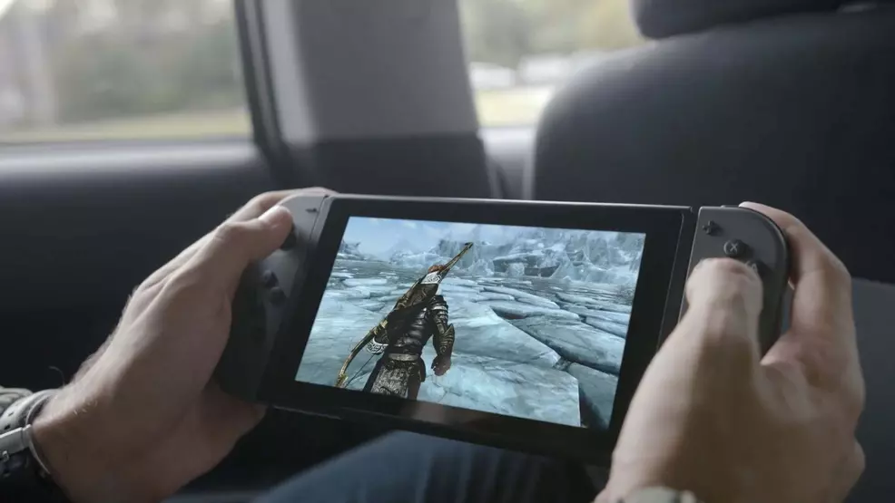 A person playing scirim in handheld mode on a switch.