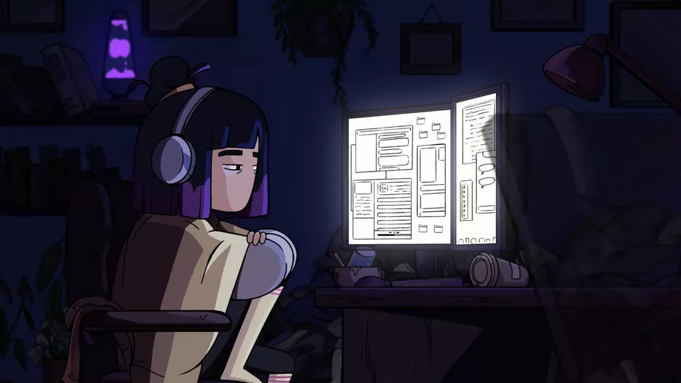 Constance sitting at a desk, staring glumly at a computer monitor.